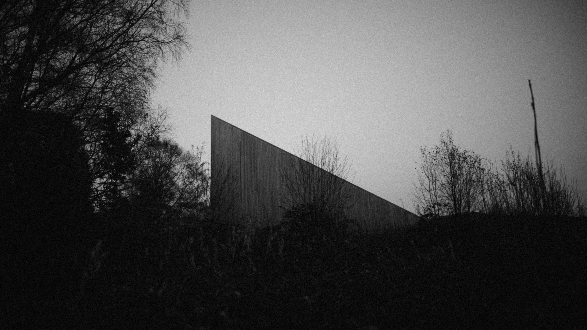Angular institutional building beneath an open sky